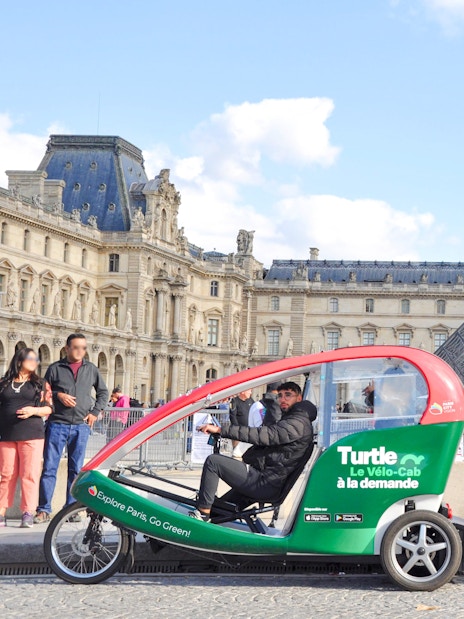 Turtle transport vehicles in front of the Louvre Pyramid, Paris.