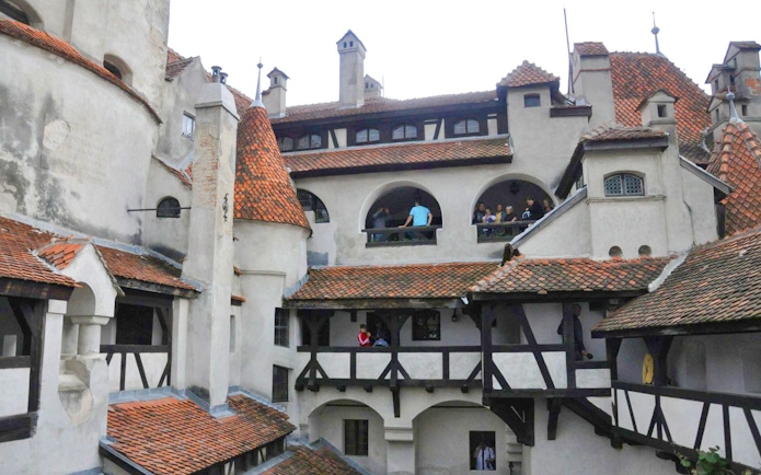 Bran Castle courtyard with visitors exploring historic architecture.