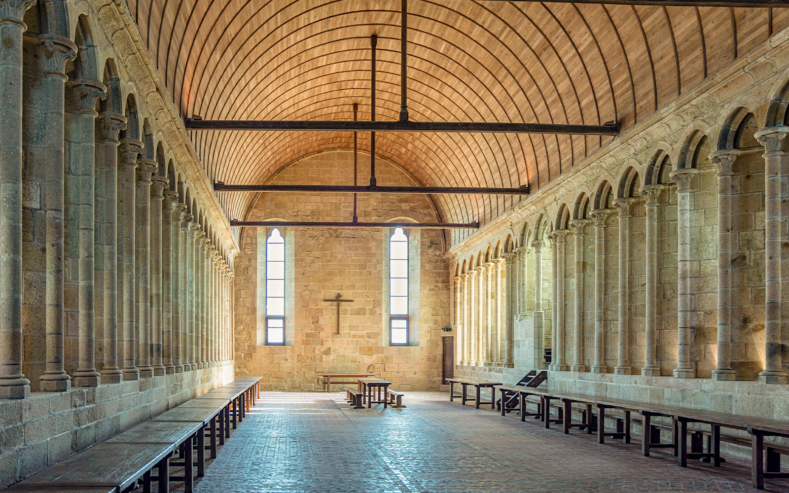 Interior arches and stone columns of Mont Saint Michel Abbey in France.