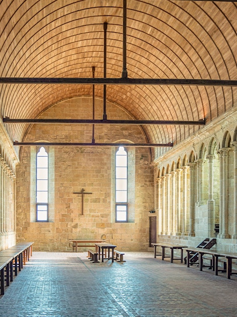 Interior arches and stone columns of Mont Saint Michel Abbey in France.