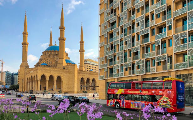 Red double-decker bus near Mohammad Al-Amin Mosque in Beirut.