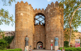 Entrance to Poble Espanyol with stone towers and statues in Barcelona, Spain.