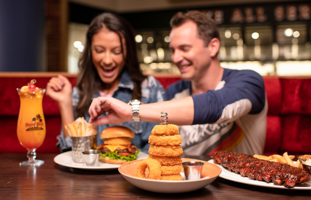 Couple dining with burgers and drinks at Hard Rock Cafe