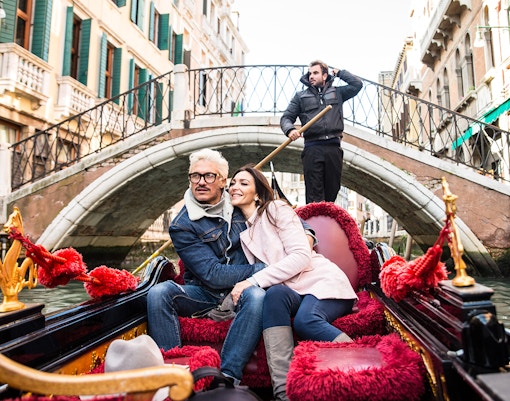Water bus on Venice Grand Canal with historic buildings in the background.