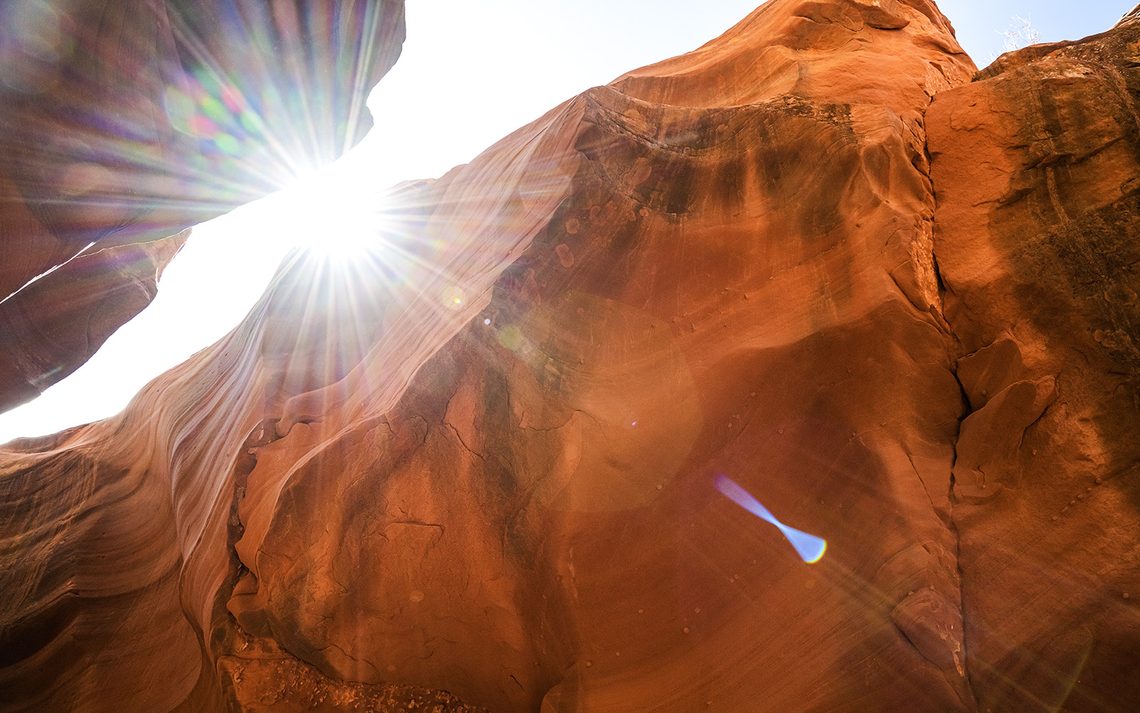 Sunlight streaming through rock formations in Waterhole Canyon.