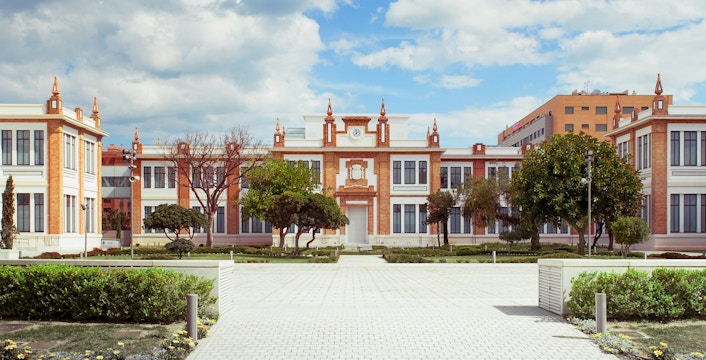 Russian Museum of Malaga exterior with red brick facade and landscaped gardens.