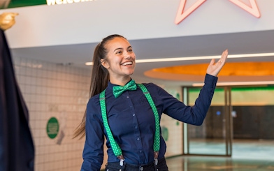 Guide welcoming visitors at Heineken Experience in Amsterdam.