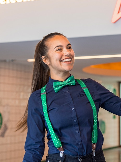 Guide welcoming visitors at Heineken Experience in Amsterdam.