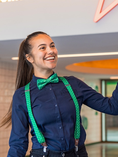 Guide welcoming visitors at Heineken Experience in Amsterdam.