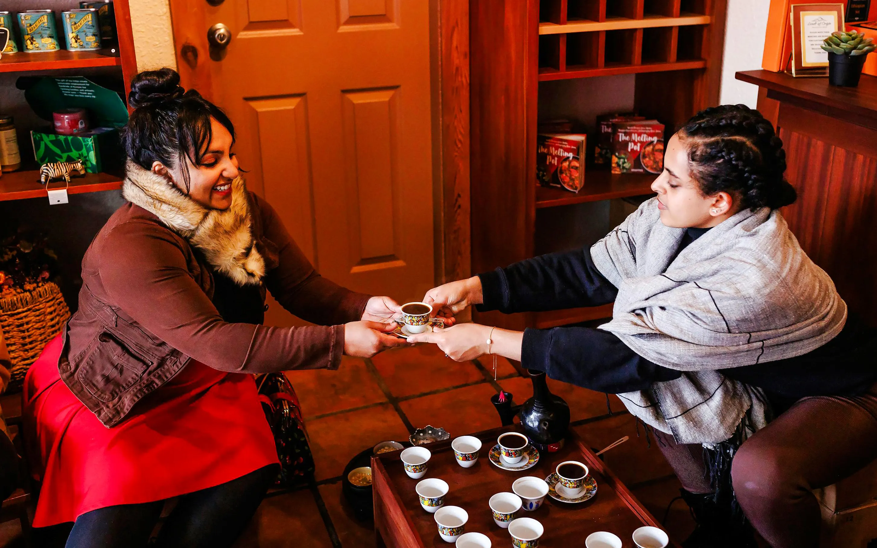 Two people sharing coffee during a VIP morning market experience.