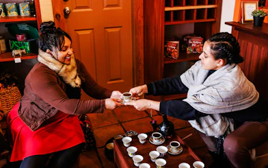 Two people sharing coffee during a VIP morning market experience.