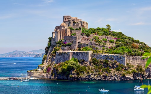Castle on a cliff overlooking the sea in Naples, Italy.