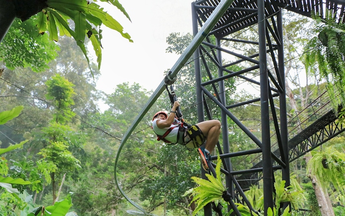 Ziplining through lush forest at Hanuman World, Thailand.