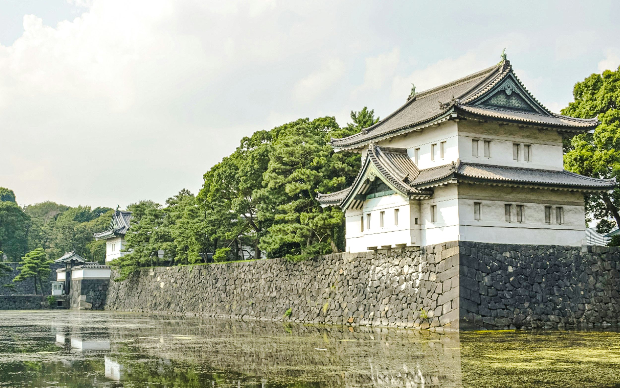 Tokyo Imperial Palace with traditional architecture and surrounding moat.