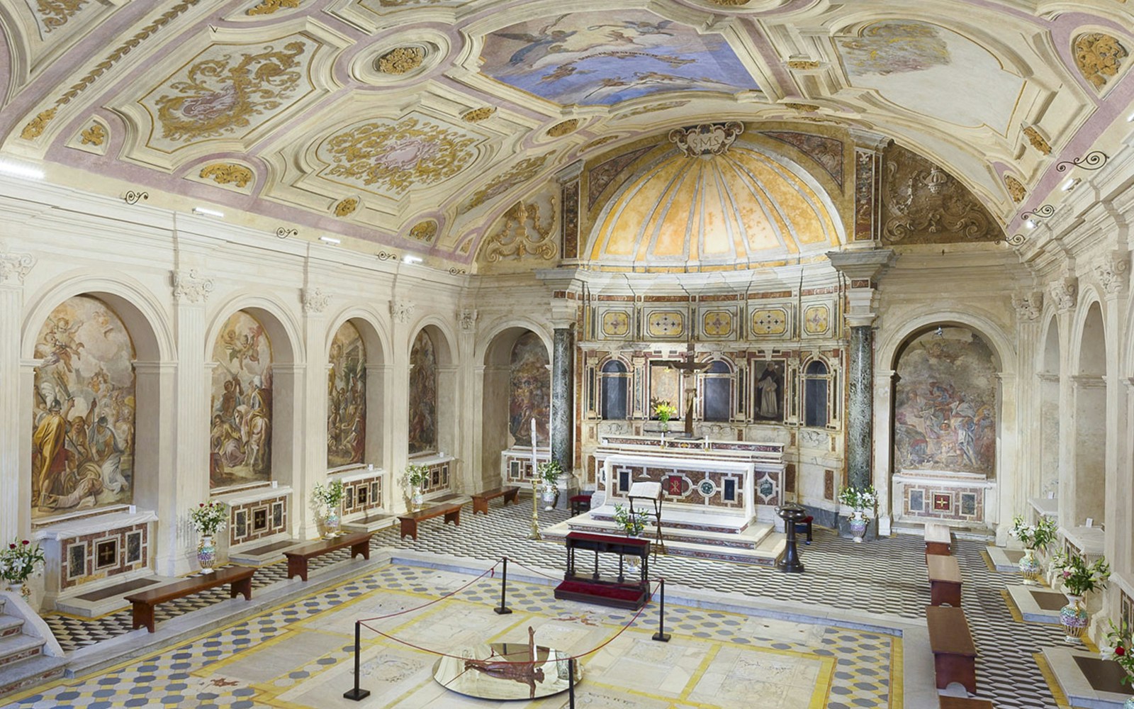Catacombs of San Gennaro interior with marble ceilings and tiled floors.