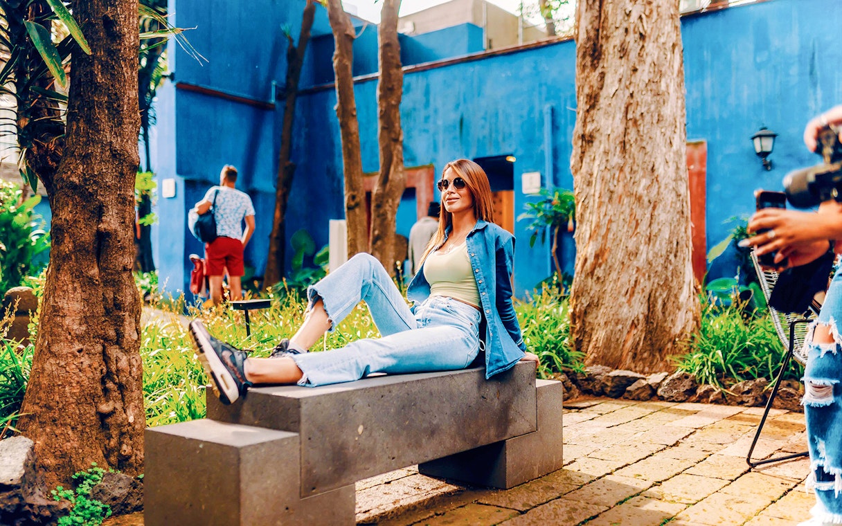 Visitors relaxing in the garden of the Frida Kahlo Museum, Mexico City.