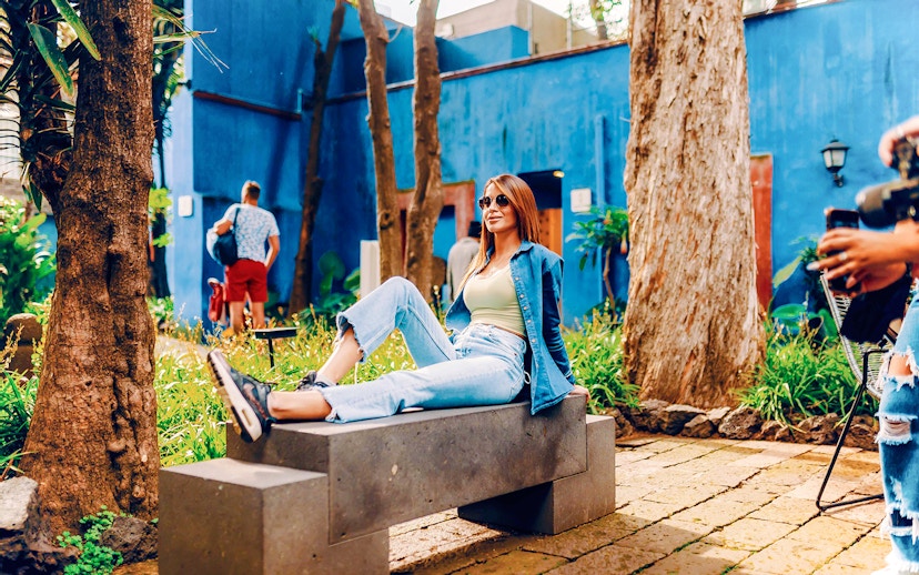 Visitors relaxing in the garden of the Frida Kahlo Museum, Mexico City.