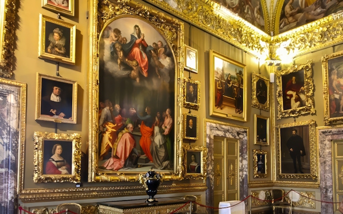 Paintings in ornate frames at the Pitti Palatine Gallery, Florence.