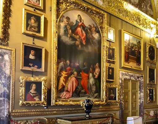 Paintings in ornate frames at the Pitti Palatine Gallery, Florence.