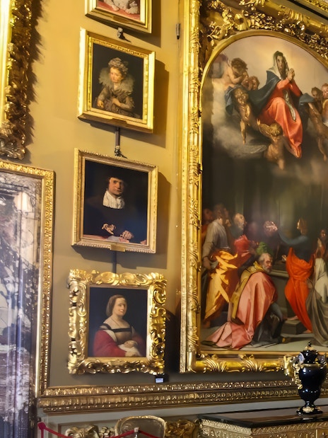 Paintings in ornate frames at the Pitti Palatine Gallery, Florence.