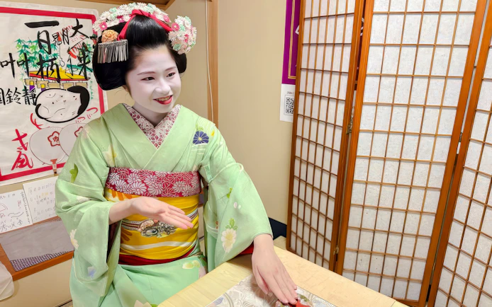 Maiko in traditional attire performing a tea ceremony in Kyoto.