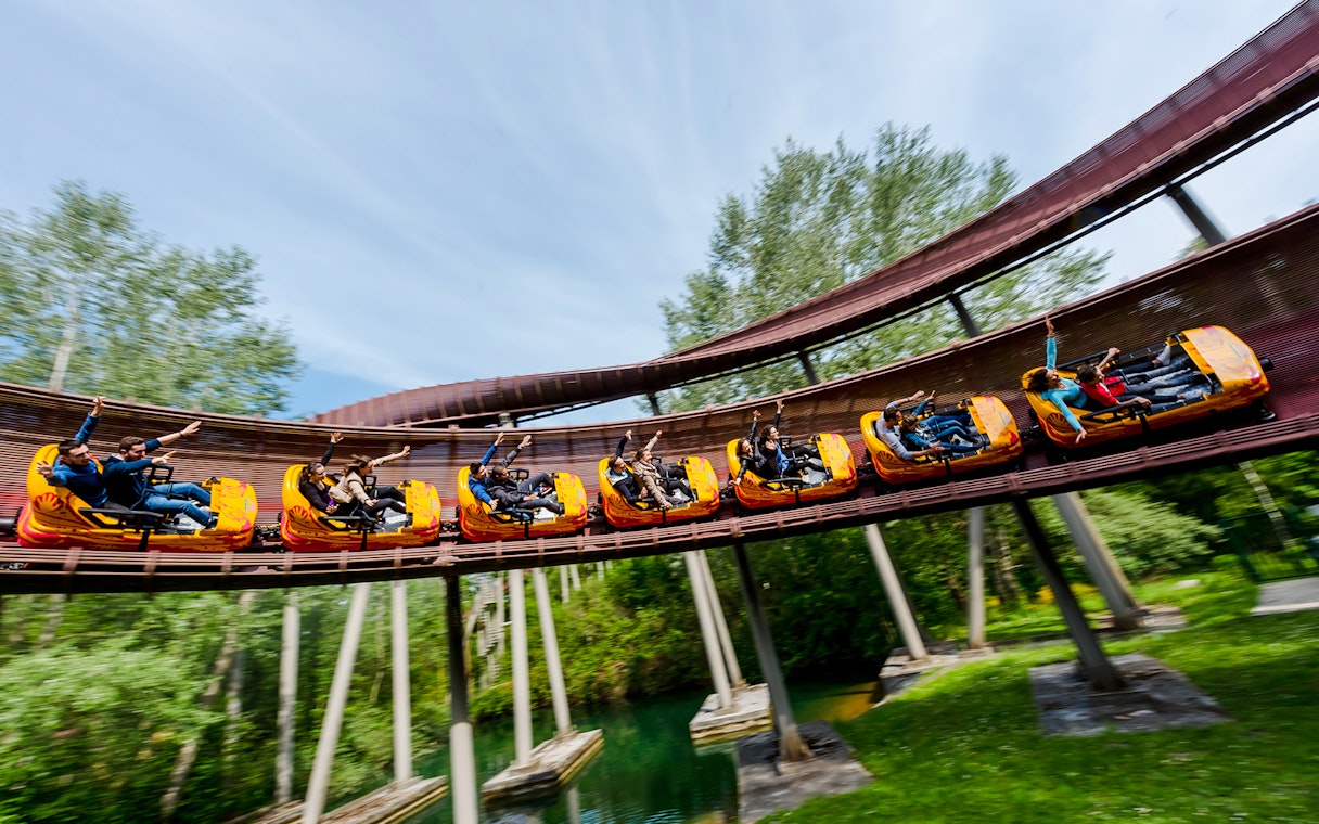 Roller coaster ride at Parc Asterix with people enjoying the thrill.