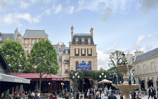 Ratatouille The Adventure entrance at Disneyland Paris with fountain and visitors.