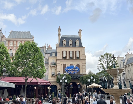 Ratatouille The Adventure entrance at Disneyland Paris with fountain and visitors.