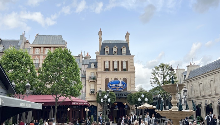 Ratatouille ride entrance at Disneyland Paris with Remy statue and themed decor.