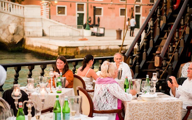Guests dining on a galleon during a dinner cruise in Venice.