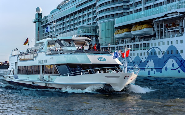 Cruise ship navigating Hamburg Harbor during 2-hour XXL tour.