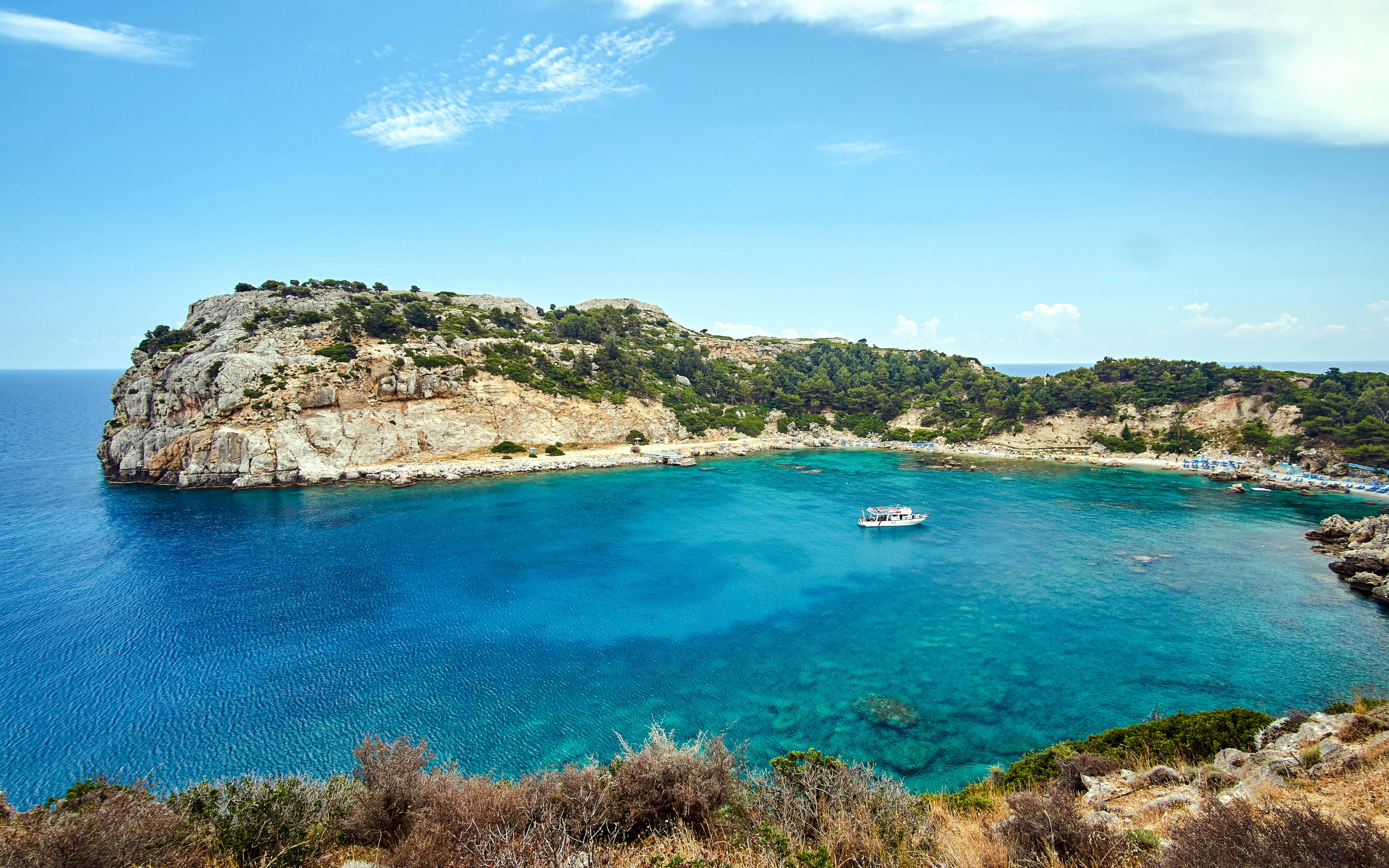 Anthony Quinn Bay view during Rhodes cruise, Greece, with clear blue waters and rocky cliffs.