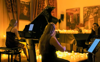 Candlelit performance of Queen music at Chopin Gallery, Krakow with musicians playing piano and strings.