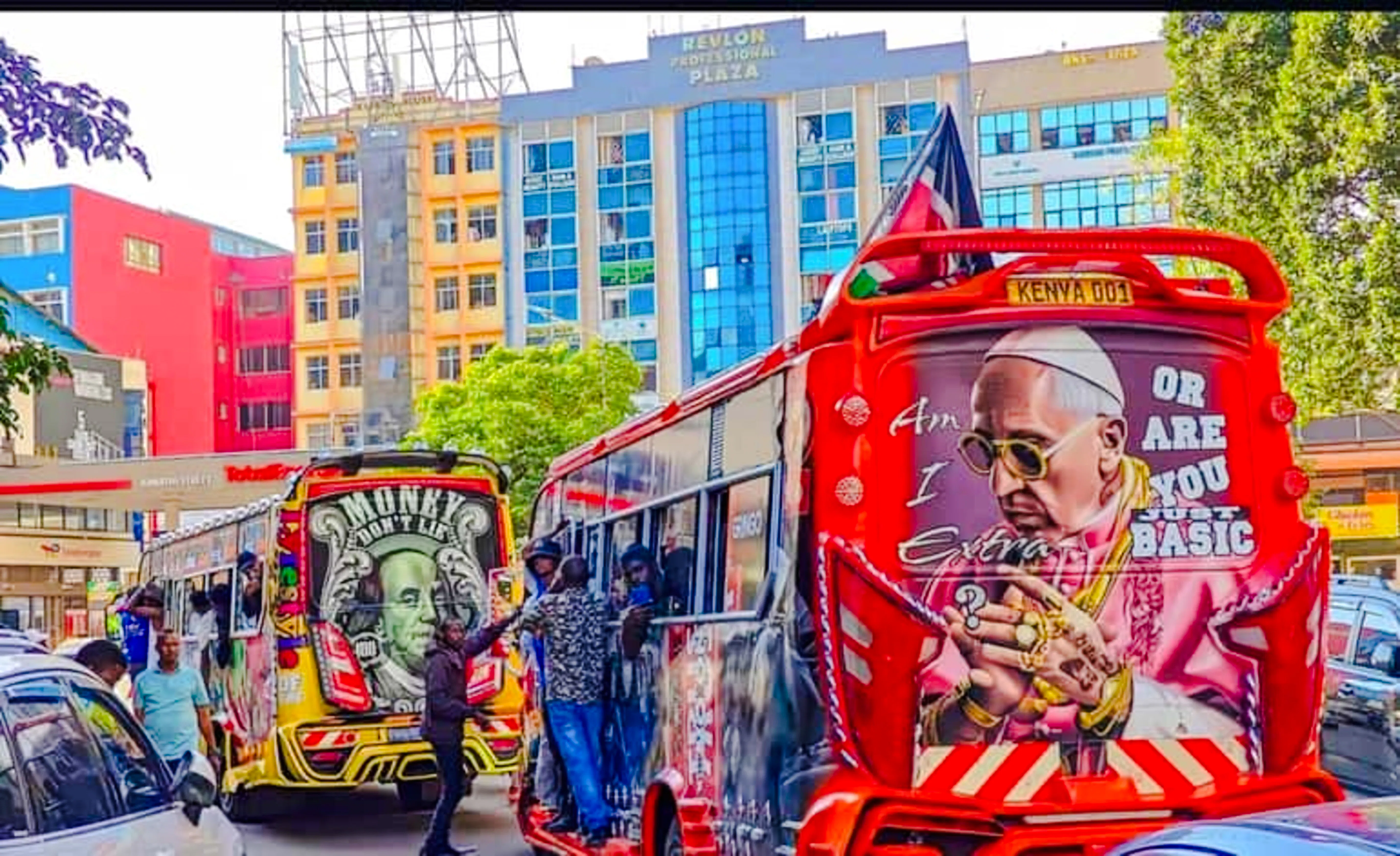 Colorful matatus with street art in Nairobi city center during guided walking tour.