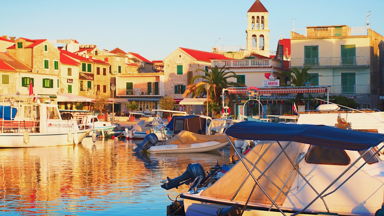 Boats docked at the port in Vodice, central Dalmatia, Croatia, with historic buildings in the background.