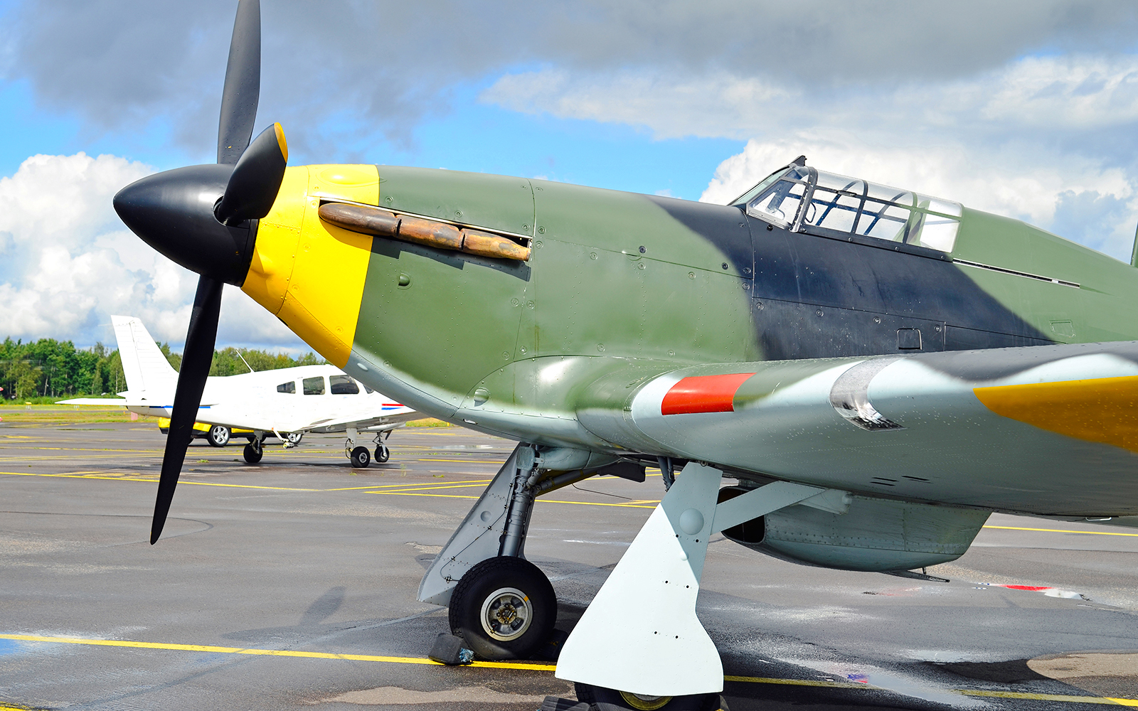 WW2 fighter plane displayed in an airport hangar.