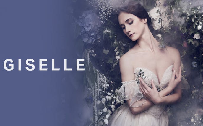 Ballet dancer in a floral setting for Giselle performance.