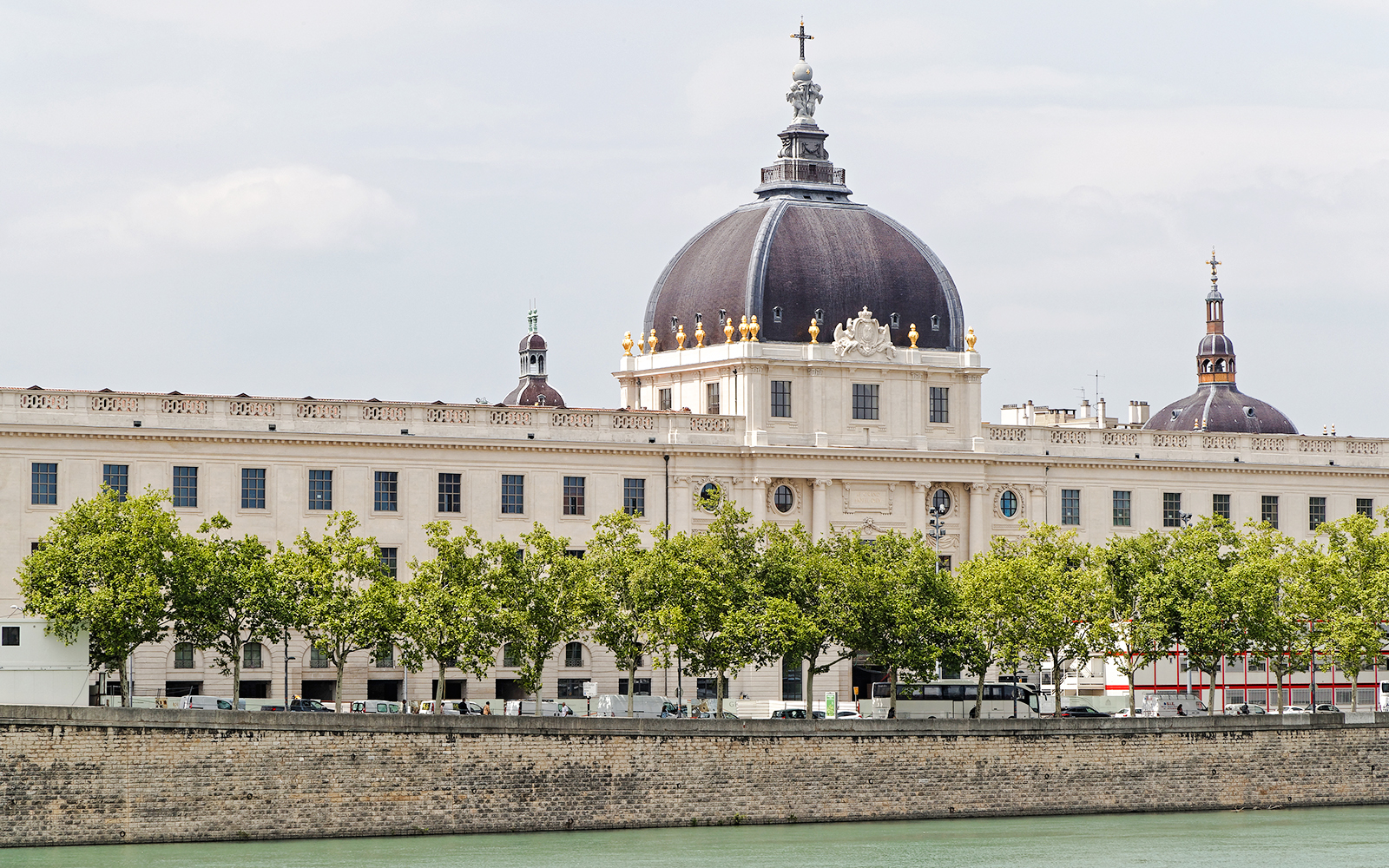 Le Grand Hôtel-Dieu Lyon with its iconic dome and riverside view.