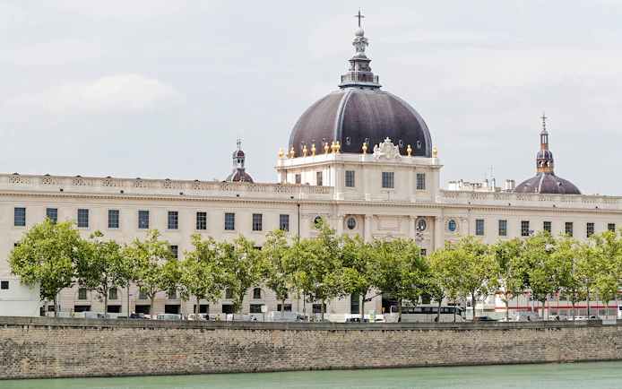 Le Grand Hôtel-Dieu Lyon with its iconic dome and riverside view.