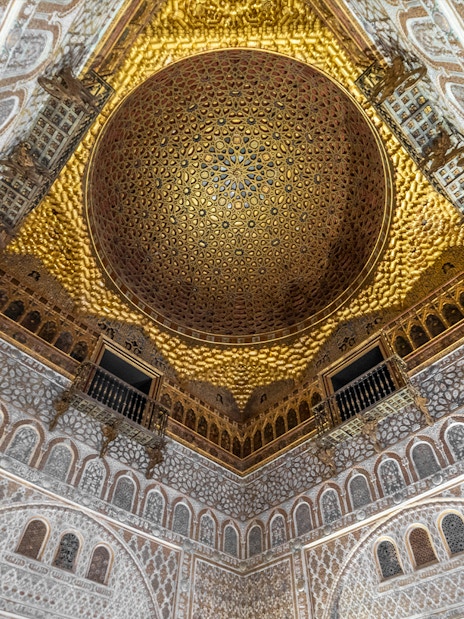 Alcazar of Seville gold ceiling with intricate patterns, Andalusia, Spain.