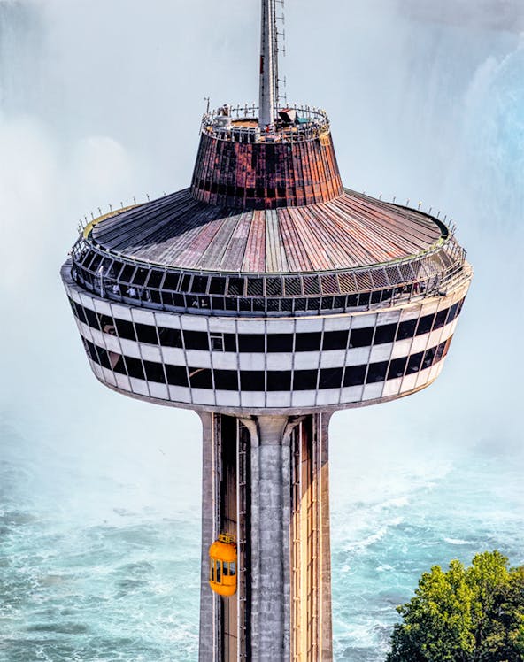 Skylon Tower observation deck with yellow elevator overlooking Niagara Falls.