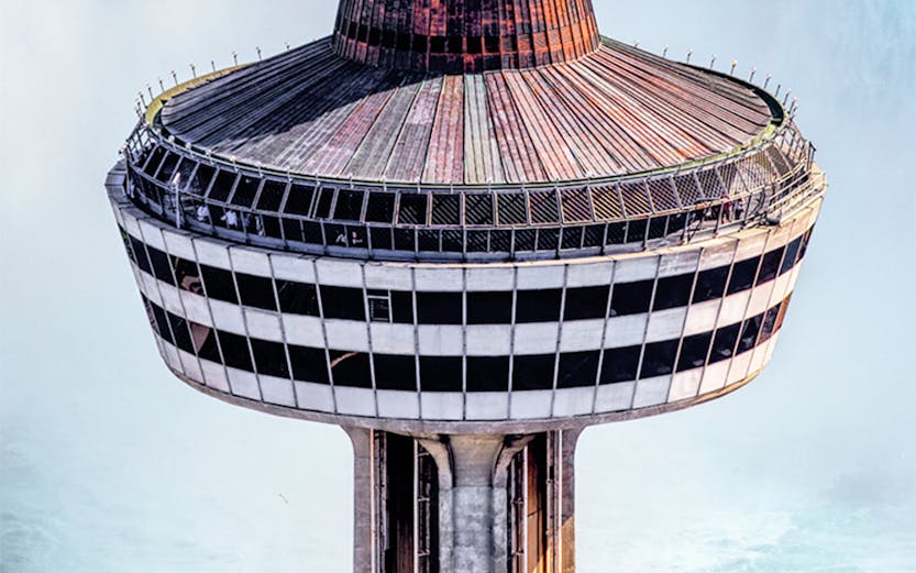 Skylon Tower observation deck with yellow elevator overlooking Niagara Falls.