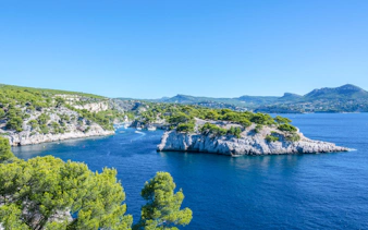 Sailing near rocky coastline of Frioul Archipelago with view of Châteaux d’If in Marseille, France.