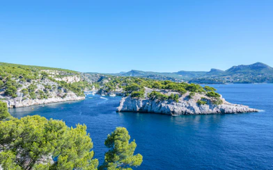 Sailing near rocky coastline of Frioul Archipelago with view of Châteaux d’If in Marseille, France.