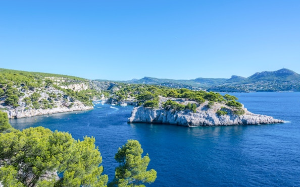 Sailing near rocky coastline of Frioul Archipelago with view of Châteaux d’If in Marseille, France.