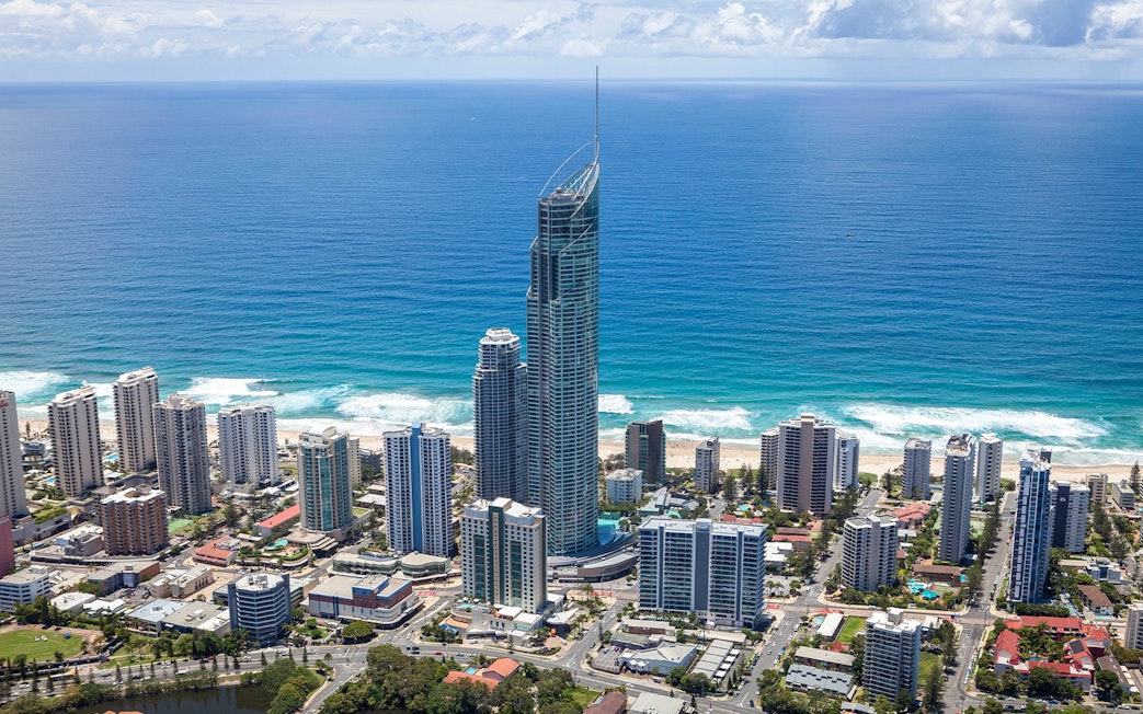 Aerial view of Gold Coast skyline with SkyPoint Observation Deck towering above the city and ocean.