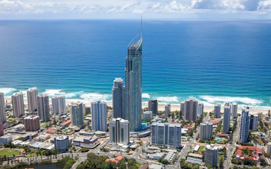 Aerial view of Gold Coast skyline with SkyPoint Observation Deck towering above the city and ocean.