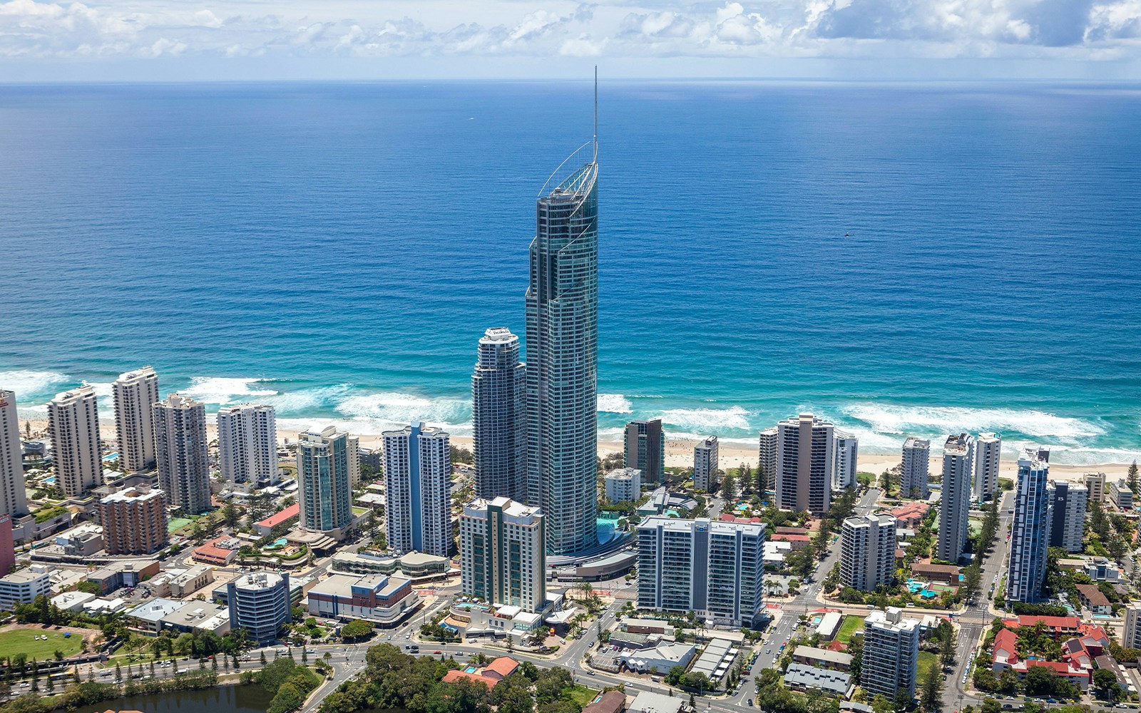 Aerial view of Gold Coast skyline with SkyPoint Observation Deck towering above the city and ocean.