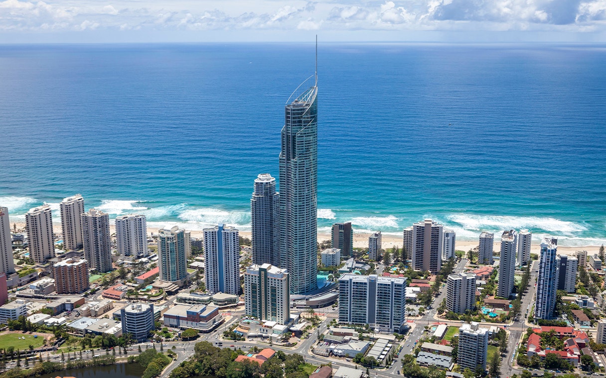 Aerial view of Gold Coast skyline with SkyPoint Observation Deck towering above the city and ocean.