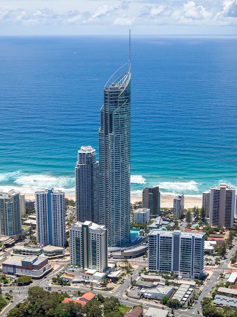 Aerial view of Gold Coast skyline with SkyPoint Observation Deck towering above the city and ocean.